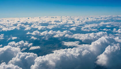 The view from an airplane window showing fluffy white clouds against a blue sky