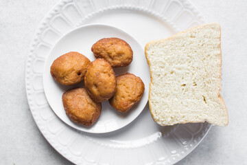 Akara and bread on a white plate, nigerian akara fried beans cake and bread on a plate 