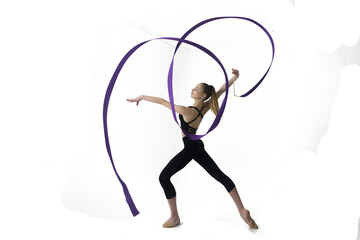 young gymnast in a photo studio shows the elements of exercises with a ribbon, doing stretching and rotating it, 
isolated on transparent background, png