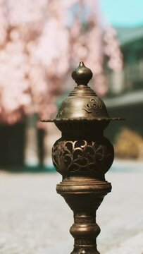 Detailed view of a metal object lying on the sidewalk.