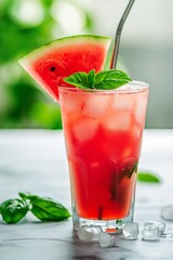 A glass of watermelon juice with a slice of watermelon on top