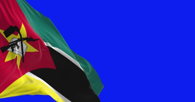 Close-up of Mozambique national flag waving isolated on blue background