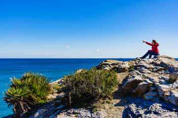 Tourist woman on sea cliffs in Spain