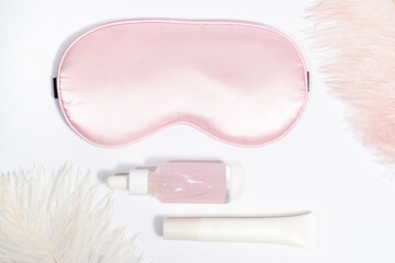 Beauty sleep essentials with pink sleeping mask and skincare