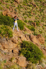 Tourist woman with camera outdoors