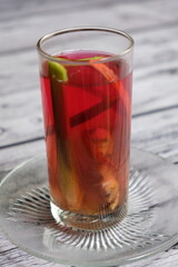 Wedang Jahe on a wooden table. A traditional herbs drink from Java Island, Indonesia, Its made of ginger, lemongrass, clove, some herbs, and rock sugar.