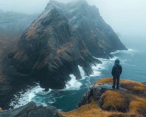 Traveler dark jacket stands cliff edge coastal landscape rocky cliffs crashing waves misty sky - Powered by Adobe