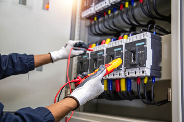 Electricity and electrical maintenance service, Engineer hand holding AC voltmeter checking...