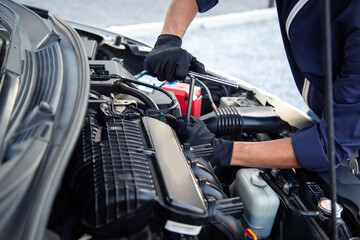 Professional mechanic working on the engine , repairing a car engine automotive workshop with a wrench, car service and maintenance,Repair service.