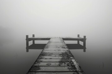 Fototapeta premium A serene dock on a misty lake. Perfect for nature and relaxation concepts