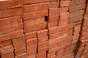 Fototapeta premium pile of red bricks neatly arranged, pattern