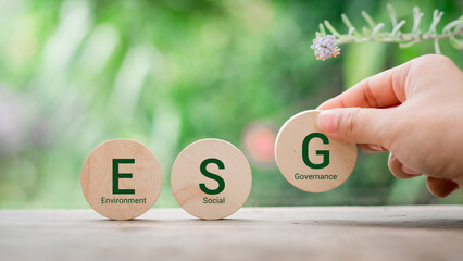 wood block with icon ESG, environment social governance investment business concept and sustainable...