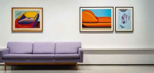 Eclectic art gallery with a lavender sofa and one horizontal poster frame showcasing avant-garde art, on a stark white wall.