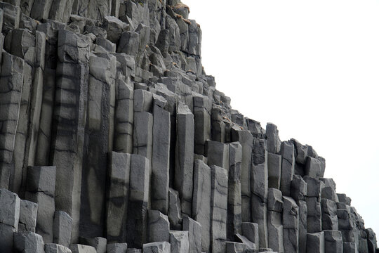 Vertical basalt column background pattern, showing the geometric hexagonal basalt rock. Reynisfjara beach, Iceland     