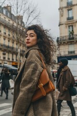 Fototapeta premium A woman walking down the street in a coat. Suitable for fashion or urban lifestyle concepts