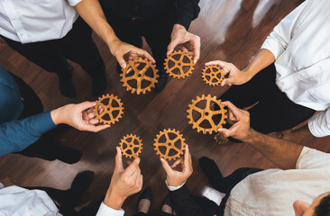 Business team joining cogwheel in circular together symbolize successful group of business...