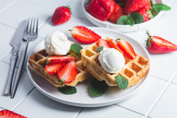 Belgian waffles with strawberries and ice cream