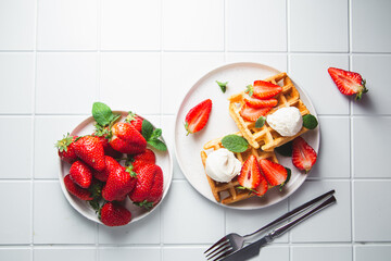Belgian waffles with strawberries and ice cream