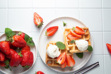 Belgian waffles with strawberries and ice cream