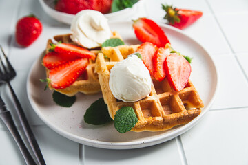 Belgian waffles with strawberries and ice cream