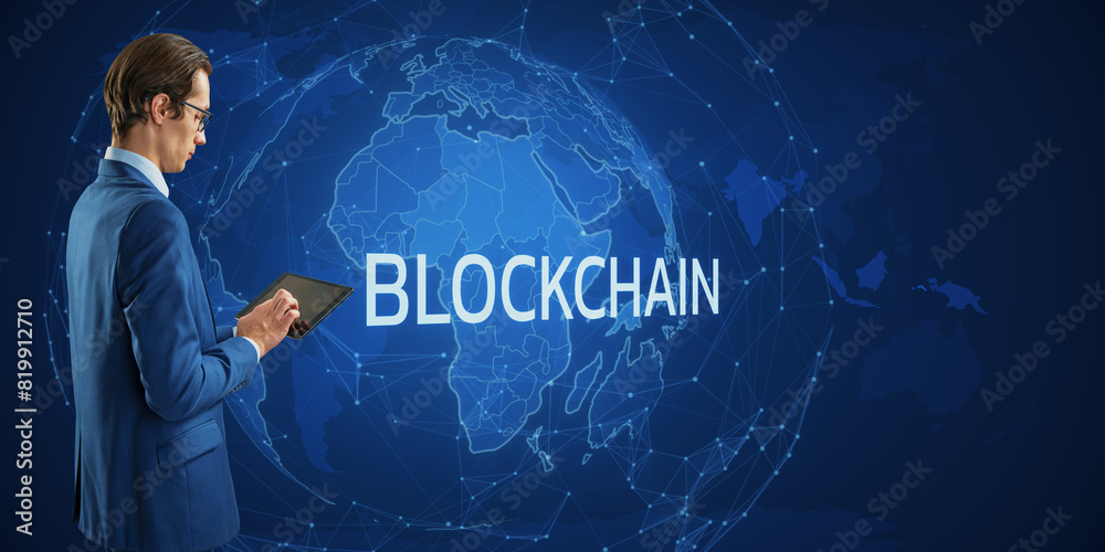 Aufkleber A man in a suit using a tablet with BLOCKCHAIN text and digital world map in the background, concept of technology