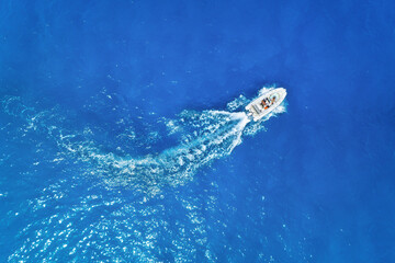 Aerial view on fast boat on blue sea at sunny day. Vacation and leisure. Fast ship on the sea...