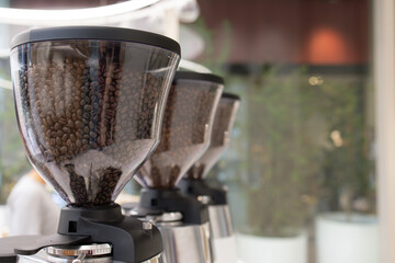 Three coffee grinders are lined up