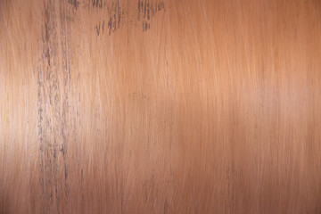 A wooden surface with a brownish color and some scratches
