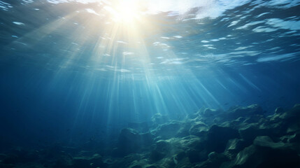 Underwater sun rays shining through the ocean surface