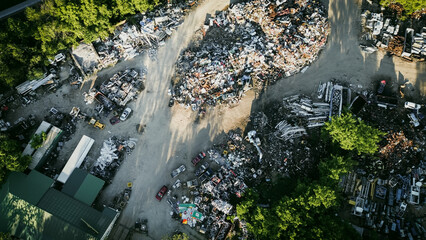 Toned photo mound of ferrous, nonferrous scrap metals, vehicle parts at large recycling center,...