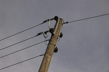 A tall power pole with wires on it