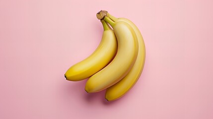 Bunch of yellow bananas on pink background top view angel