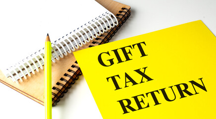 GIFT TAX RETURN text on yellow paper with notebooks