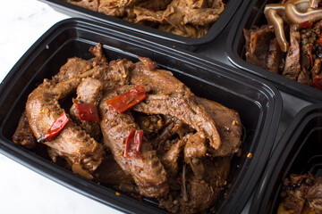 Chinese take out food spicy duck wings in a container