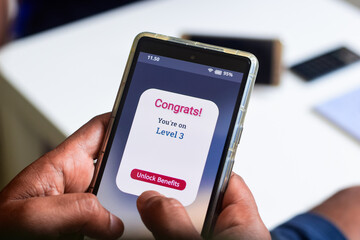 Customer level loyalty rewards concept. Man got a congratulatory message of level up earning. 