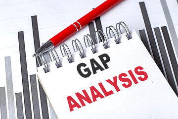 GAP ANALYSIS text on notebook on chart with pen
