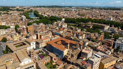 Aerial view of houses and buildings in the Trastevere district in Rome, Italy. It is one of the most touristy districts in the historic center of the Italian capital and is located on the Tiber River.