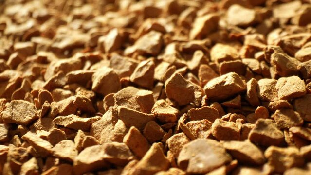 Freeze-dried coffee granules: Golden-brown pebbles, rough and rugged, promising an instant coffee kick. Each granule a miniature powerhouse, waiting to dissolve into your perfect cup.
