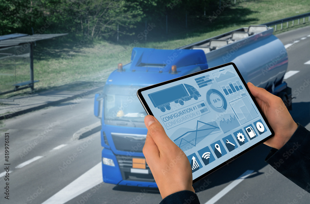 Poster Manager with a digital tablet on the background of truck. Fleet management..