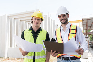 Team of male engineer construction working and inspecting structure of building at construction site. Two male construction builder working at construction site
