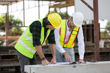 Team of male engineer construction working and inspecting structure of building at construction...
