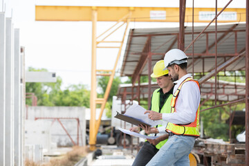 Team of male engineer construction working and inspecting structure of building at construction...