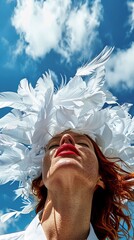 Bold woman with extravagant white feather headdress against blue sky