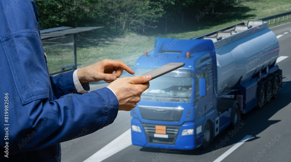 Poster Manager with a digital tablet on the background of truck. Fleet management..