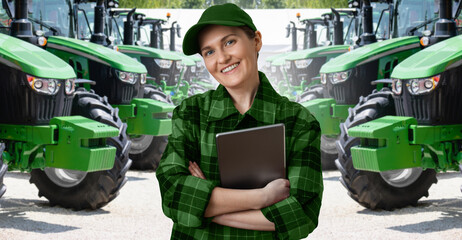 Woman farmer with a digital tablet on the background of an agricultural tractors