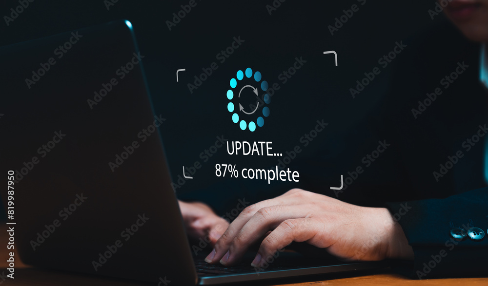 Fototapete Businessman updating computer system for device operating system to be up to date with new version. Graphics icon showing updating function screen loading on computer laptop.