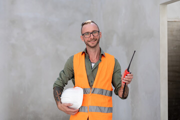 Caucasian Male technician engineer construction worker working in building structure site wearing...
