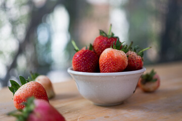 Juicy-washed strawberries against nature background