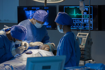 Surgeons team working with Monitoring of patient in surgical operating room. The doctors and nurses...