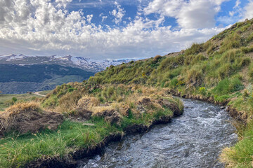 Water stream flowing from melting snow in the spring, Sierra Nevada range, Andalusia, Spain